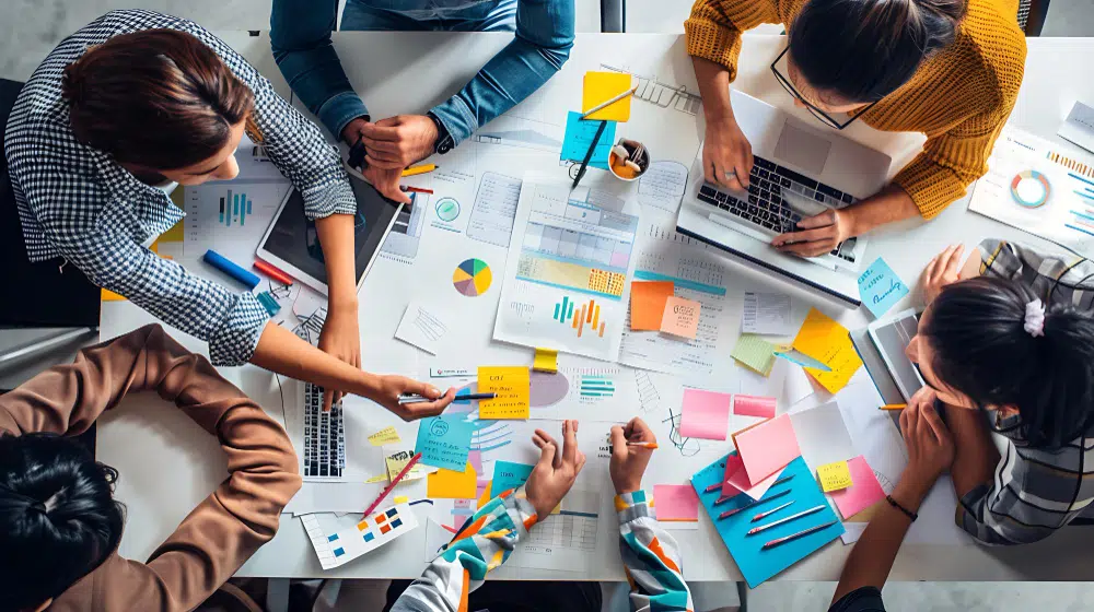 HR Software Auswahl: Aktuelle Auswahlkriterien HR-Team analysiert Trends und Kriterien für die HR Software Auswahl gemeinsam an einem großen Tisch.